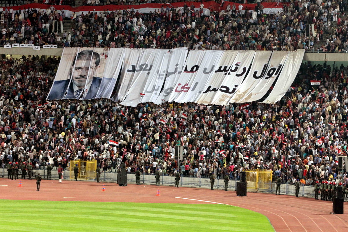 Crowds fill Cairo stadium to witness President Morsy’s speech on the anniversary of the 6 October War. The banner reads ‘First civilian president after October’s victory’ Mohamed Omar