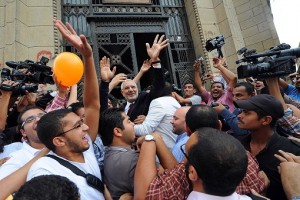 Abdel Moneim Abul Fotouh waves to supporters on the steps of the Supreme Court as he arrives to register the Strong Egypt party. (PHOTO BY MOHAMED OMAR)