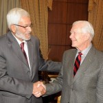 Jimmy Carter shakes hands with constituent assembly head Hossam El-Gheriany at the Shura Council. (PHOTO BY MOHAMED OMAR)