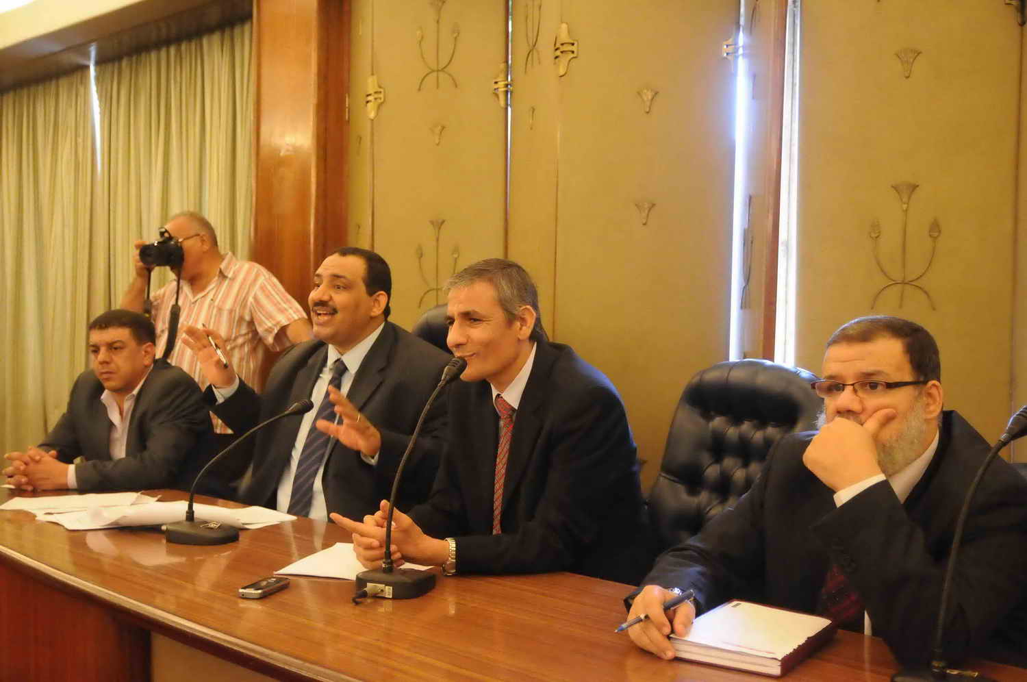 Former MP Mohamed El-Omda, left, speaks alongside colleagues in the Parliament building Mohamed Omar