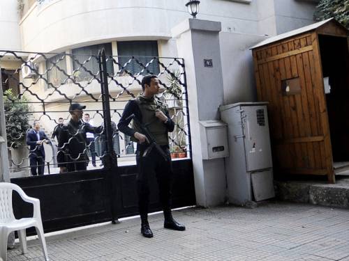 Security forces stand outside the offices of one of the NGOs raided in December 2011 (File photo) AFP PHOTO
