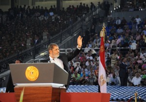 President Mohamed Morsi waves at the crowd as he delivers his speech to the nation in Cairo Stadium, in Cairo, to mark the 39th anniversary of the Yom Kippur war against Israel AFP PHOTO / HO / EGYPTIAN PRESIDENCY