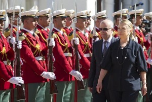 Algerian Foreign Minister Mourad Medelci walks alongside US Secretary of State Hillary Clinton as she arrives for meetings at the Mouradia Palace in Algiers. (AFP PHOTO / SAUL LOEB)