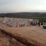 Syrian volunteers set up tents for refugees in the northwestern Syrian village of Qah AFP PHOTO / HERVE BAR