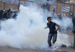 An Egyptian man throws back a teargas canister fired by policemen as hundreds of Coptic Christians marched in Cairo on 17 November 2011 to demand justice for the Christian victims of the massacre at Maspero the previous month  AFP PHOTO / STRINGER