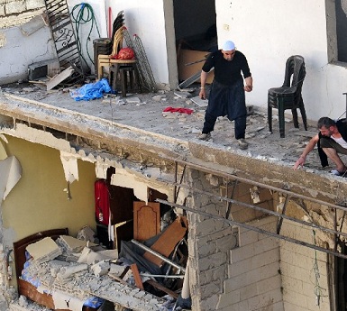 A handout picture released by the Syrian Arab News Agency (SANA) shows residents inspecting the damage caused by an explosion in the Syrian capital Damascus on Monday (AFP PHOTO / HO / SANA)