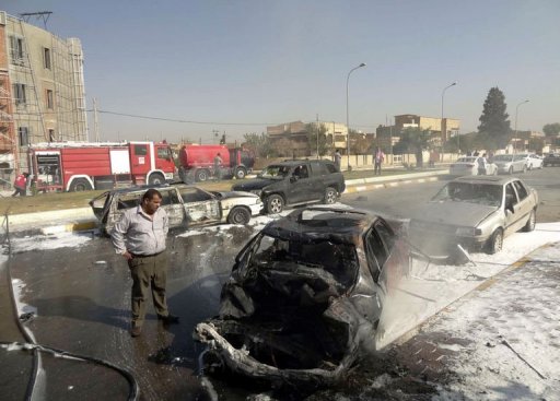 A man looks at destroyed vehicles following two car bombs near the provincial government headquarters in Kirkuk. (AFP/ Marwan Ibrahim)