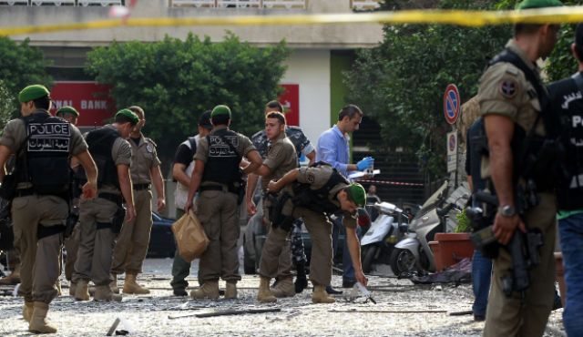 Lebanese security forces inspect damages in Beirut's predominantly Christian district of Ashrafieh on October 20, 2012, a day after a deadly car bomb blast. Photo by AFP