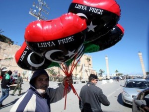 A Libyan holds balloons in the colours of the new national flag in Tripoli.  (AFP Photo)