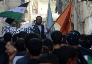A rebel commander addresses demonstrators in Aleppo (AFP/File, Tauseef Mustafa)