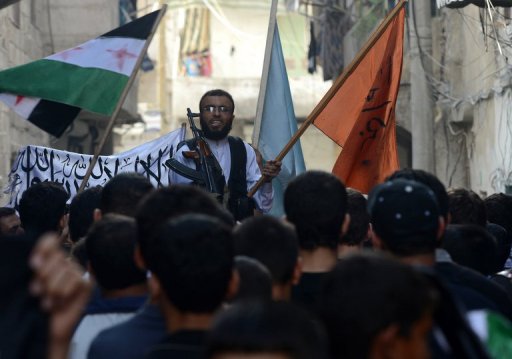 A rebel commander addresses demonstrators in Aleppo (AFP/File, Tauseef Mustafa)