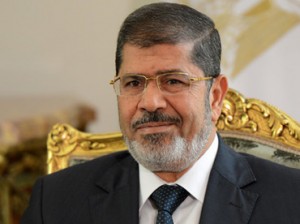 President Mohamed Morsi said on Saturday on his official Twitter account that a cabinet reshuffle and the appointments of new governors are to be announced “soon”. (AFP Photo / Khaled Desouki)