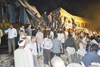 Crowds gather at the scene of a train collision in Fayoum. (PHOTO BY MOHAMED OMAR)