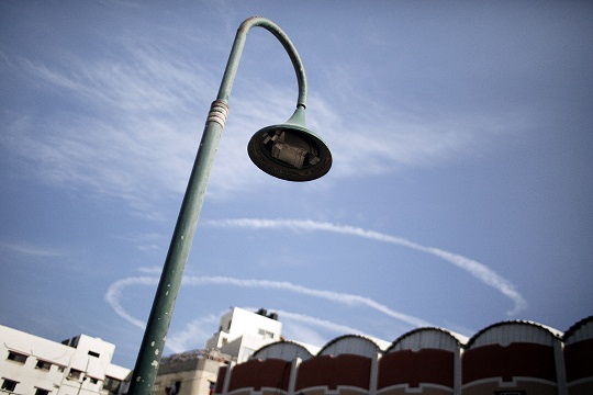 The white spirals of a patrolling Israeli drone are seen from the seafront in Gaza City. (AFP PHOTO / Marco Longari)