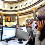 Dealers are seen at the Egyptian stock exchange market in Cairo. Only seven stocks rose, 156 fell and nine remained unchanged Photo by Mohamed Omar
