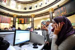Dealers are seen at the Egyptian stock exchange market in Cairo. Only seven stocks rose, 156 fell and nine remained unchanged Photo by Mohamed Omar