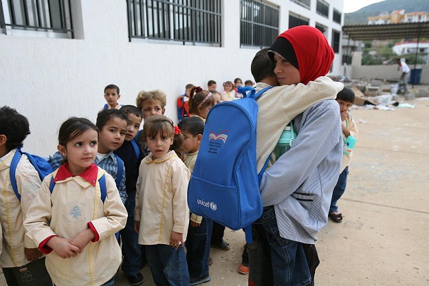 Children line up at a charity supported school in Cairo. (AFP PHOTO)