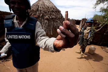 A handout picture released by the United Nations-African Union Mission in Darfur shows a staff member holding a spent cartridge left behind by local militants. (AFP PHOTO / UNAMID / ALBERT GONZALEZ FARRAN)