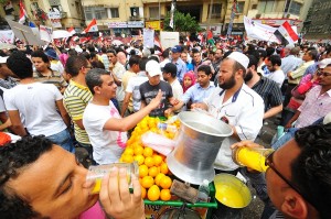 Street vendors does a swift trade in fresh orange juice during a protest in Tahrir square Hassan Ibrahim