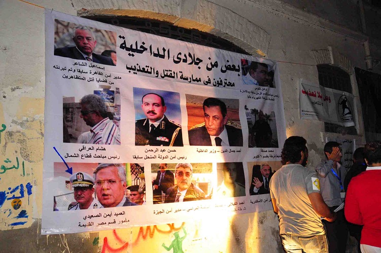 Murals and posters at a memorial rally for Essam Attam shows police and security force commanders who campaigners believe are responsible for torture and abuse of detainees Hassan Ibrahim