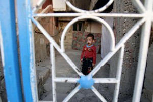 Deeb, a two-year-old Syrian refugee who arrived in Lebanon with his parents more than a year ago, stands outside the house his family is staying in the northern Lebanese town of Halba AFP Photo / Anwar Amro