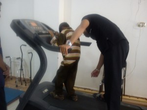 Islam is helped by a centre worker during a physiotherapy session Adham Roshdy