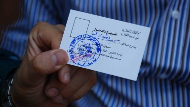 After an attempt to regulate street vendors on Talaat Harb street one man shows his new license that entitles him to sell from a fixed spot along the road Mohamed Omar