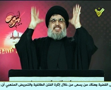 An image grab from Hezbollah's Al-Manar TV shows Hassan Nasrallah, the head of Lebanon's militant Shi'a Muslim movement Hezbollah, gesturing as he addresses thousands of Shiite Muslims gathered for Ashura. (AFP PHOTO / HO / AL-MANAR)