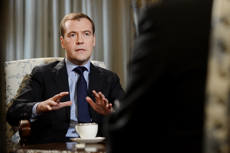 Russia's Prime Minister Dmitry Medvedev (L) speaks during an interview with Agence France Presse in the Gorki outside Moscow.(AFP PHOTO / NATALIA KOLESNIKOVA)