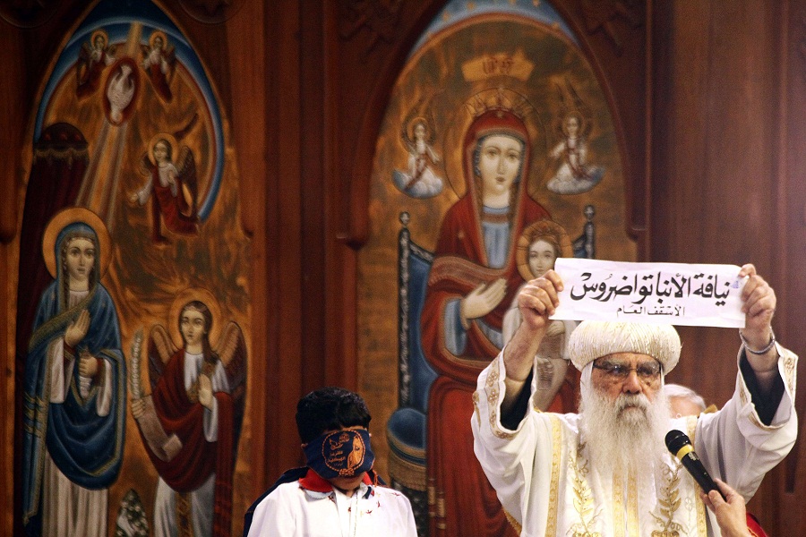 Egyptian caretaker of the Coptic Church Bishop Pachomius shows the ballot bearing the name of Bishop Tawadros in Arabic AFP PHOTO / MAHMUD KHALED