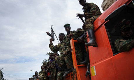 M23 paramilitaries celebrate in the streets after taking Goma. Photograph. (AFP / GETTY IMAGES / Phil Moore)
