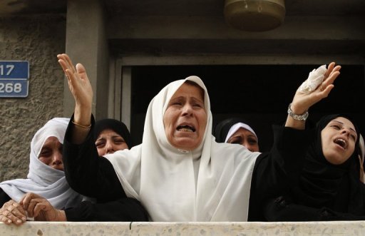 Relatives of an 18-year-old Palestinian civilian mourn his death in the clashes. (AFP / MOHAMED ABED)