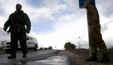 Israeli soldiers stand guard in Alonei Habashan in the Israeli-occupied Golan Heights, on November 11, 2012. (AFP PHOTO / JALAA MAREY)