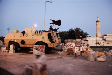 gyptian soldiers stand on top of an Egyptian armoured personnel carrier at a military checkpoint on the Egyptian side of Rafah, in the northern Sinai on August 10, 2012. (AFP PHOTO / MOSTAFA ABULEZZ)