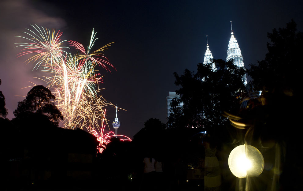 Residents watch fireworks displays above the Malaysia's iconic landmarks, the Twin Towers, during the new year celebrations in Kuala Lumpur, on January 1, 2012. Saeed Khan/AFP/Getty Images