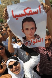 An Egyptian woman holds up portrait of alleged torture victim Khaled Said with the slogan "Suffocation of Emergency [laws]" during a demonstration after Friday prayers in Alexandria June 25, 2010, against his alleged killing by the police earlier this month. (AFP PHOTO/ KHALED DESOUKI)