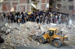Egyptian civilians and emergency services sift through the rubble of a building housing 24 families in the Maamura district of Alexandria which collapsed in the early hours on January 16, 2013. AFP PHOTO/STR