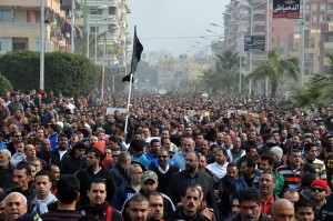Egyptian mourners march in the canal city of Port Said on 28 January 2013 during the funeral of six people killed in clashes the day before, triggered by death sentences on supporters of a local football team.  President Mohamed Morsi sought to crack down on violence which has swept Egypt since January 26 in which more than 45 people have died after a Cairo court handed down death sentences on 21 supporters of the football club, Al-Masry, in the wake of football violence in 2012. Morsi declared a month-long state of emergency in the provinces of Port Said, Suez and Ismailiya. AFP PHOTO / STR