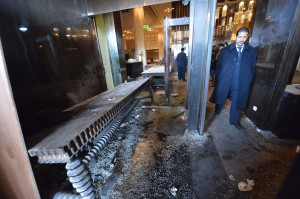 A man walks past the damage to the lobby of the Samir Amis Intercontinental Hotel after it was vandalized when protestors stormed the entrance last night, in central of Cairo on January 29, 2013. Egypt's military chief warned that the political crisis sweeping the country could lead to the collapse of the state, as thousands defied curfews and the death toll from days of rioting rose to 52. AFP PHOTO / KHALED DESOUKI