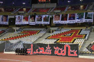 Photos of those killed in the Port Said stadium disaster hang inside Alexandria’s Borg El-Arab stadium at the start of an El-Ahly match  Mohamed Hamza