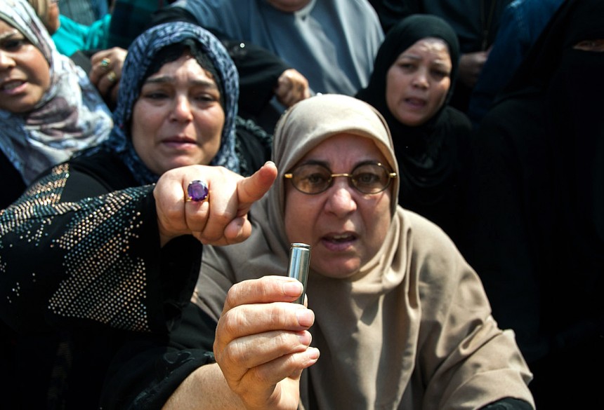 An Egyptian woman shows a live bullet during a rally in the streets of the canal city of Port Said on 29 January AFP Photo / Stringer