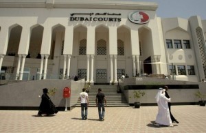 File picture shows pedestrians walk past Dubai's courts building during a hearing on April 4, 2010. The United Arab Emirates is to put on trial 94 Islamists accused of plotting against the Gulf state, attorney general Salem Kobaish announced on Sunday. (AFP PHOTO)