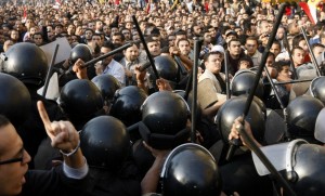 Demonstrators clash with police in central Cairo during a protest to demand the ouster of President Hosni Mubarak and calling for reforms on 25 January  (AFP Photo / Mohammed Abed)