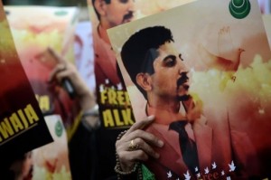 Bahraini Shi'a demonstrators hold posters of jailed activist Abdulhadi al-Khawaja (AFP/File)