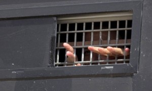 A Palestinian prisoner looks out of a jail truck as he awaits release as part of the first stage of prisoner exchange. (AFP/ Getty Images/ Jack Guez)