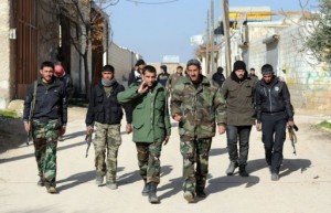 Syrian rebel commander Abu Kosai (3rd right) walks towards a regime military base in Aleppo, on January 17, 2013 (AFP, Aamir Qureshi)