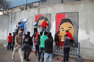Fans paint the faces of Port Said stadium victims on the walls of the Al-Ahly club grounds (Joel Gulhane)