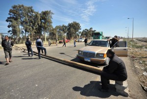 Egyptian protesters close the main road leading to Port Fouad town from the Canal city of Port Said  AFP Photo / Stringer 