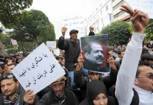 Tunisian protesters hold placards during a demonstration on 23 February on the Habib Bourguiba Avenue in Tunis, demanding that opposition leader Chokri Belaid's killers be found (AFP Photo / Fethi Belaid)