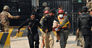 security personnel shift an injured man from the office of the top political official of Khyber tribal region in Peshawar on February 18, 2013. Militants, including a suicide bomber attacked the office of a senior official in Pakistan’s northwestern city of Peshawar on Monday, killing six people. — AFP Photo